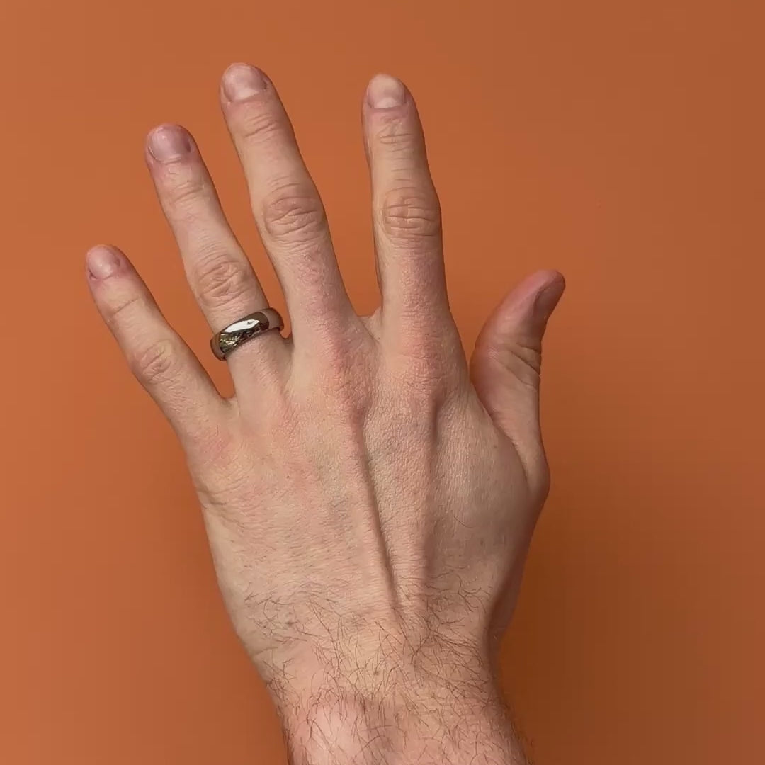 Video of a polished titanium ring on a hand. By Bound.