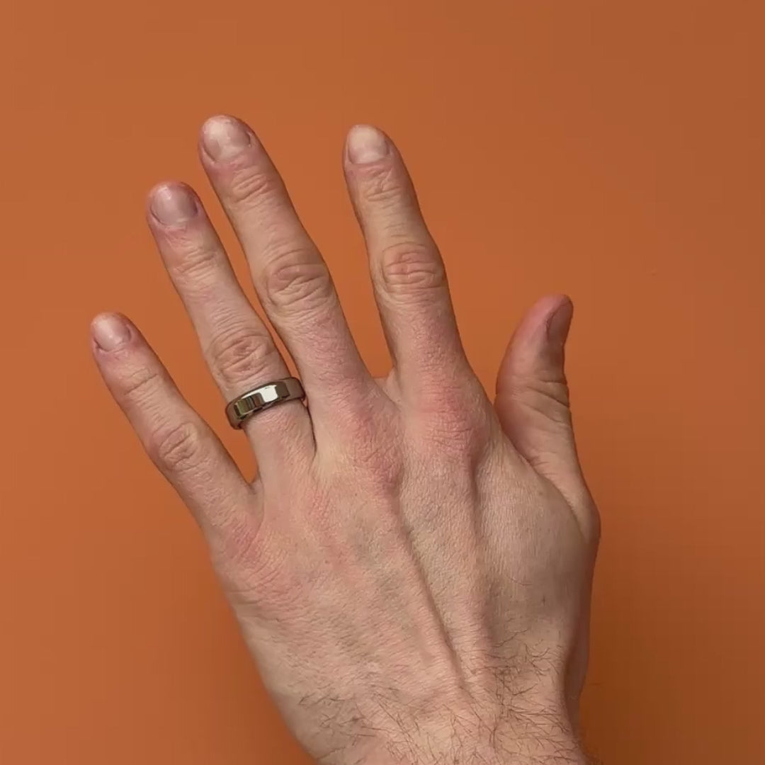 Video of a polished beveled edge titanium ring on a hand. By Bound.